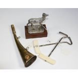 A white metal figure of a deer, a hunting horn and a pair of ivory mounted boot pulls