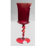 A possibly Whitefriars oversize ruby glass goblet, having inverted bell bowl, barley twist stem