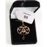 A Victorian 9ct gold seed pearl and garnet set negligee pendant, and trace link chain