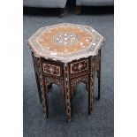 An early 20th century faux bone inlaid occasional table, the octagonal top on similarly inlaid