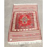 An early 20th century Belouch rug, woven with central lozenge medallion within a geometric guard and