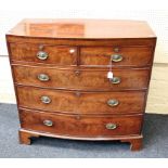 An early 19th century mahogany chest of bow front form, the boxwood strung top over two short and