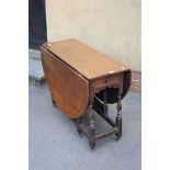 A part 18th century oak gateleg dining table, the later top over a single drawer on baluster and