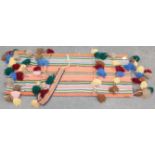 A woven and ringed 20th century camel trapping, with geometric multi coloured decoration