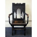 A 19th century 'Jacobethan' oak armchair, carved back with fluted baluster splats, swept scaled