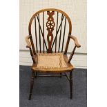 A late 19th century beech and elm wheel and stick back carver chair, with bergere cane upholstered