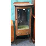 An Edwardian mahogany and satinwood crossbanded vitrine, the break bow front top over glazed door