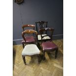 A pair of early Victorian mahogany dining chairs, with close studded burgundy hide upholstered seats