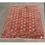 An early/mid 20th century Tekke rug, of brick red ground with three tow of guls within multiple