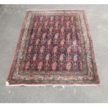 A royal blue ground Senneh rug, with all over boteh design within fishbone borders (repaired at