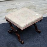 A Victorian walnut footstool, having a later upholstered seat on an X frame support and semi-