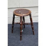 A 19th century beech stool, the circular top on ring turned tapering legs, united by a conforming