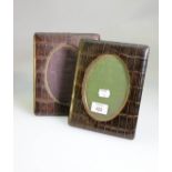 A pair of Edwardian crocodile skin covered easel photograph frames, with oval gilt metal slip