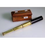 A reproduction brass hide covered three draw telescope, in a brass bound mahogany box