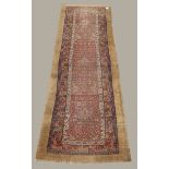 A mid 20th century Persian Seneh runner, with camel borders, 332 x 102cm