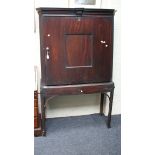 A George II Cuban mahogany cupboard, on stand with single door, raised on square supports, 114cm