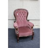 A Victorian mahogany framed and buttoned dusky pink velour upholstered parlour armchair, having