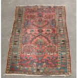 A pink ground Hamadan rug with central field of shrubs within multiple borders, 209 x 107cm