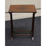 An Edwardian rosewood end table, the rectangular top on ring turned uptapering supports and