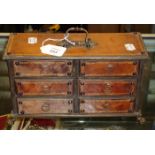 A continental leather covered and brass mounted jewellery chest of six short drawers