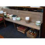 A 19th century pine church pew, with panel back and shaped ends, 239cm long