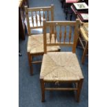 A set of six beech spindle back rush seated kitchen dining chairs