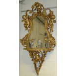 A 19th century style carved wood and gesso girandole, with courting cherubs to the cartouche,