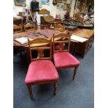 A set of six Edwardian walnut side chairs, with shaped and carved cresting rails over stuff-over
