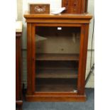 A 19th century walnut pier cabinet, the rectangular top over glazed door with coronet hinges