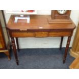 A George III mahogany and ebony strung card table, the rectangular canted top folding to a double