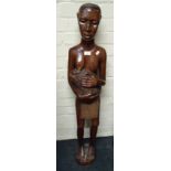 A 20th century carved African hardwood figure of a breastfeeding mother