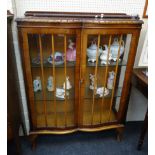 A 1930s/40s walnut two door china cabinet, on cabriole supports