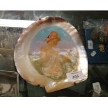 A 19th century Italian painted scallop shell depicting a bathing beauty