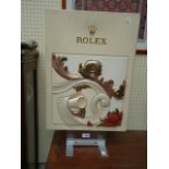 A Rolex shop display advertising sign