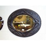 A Victorian deep carved oak oval wall mirror