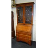 A 1920s oak fall front bureau bookcase, with leaded glass section