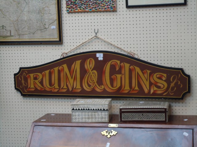 A painted and sign written saloon display board, bearing the legend 'Rum and Gins'