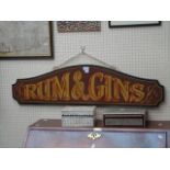 A painted and sign written saloon display board, bearing the legend 'Rum and Gins'