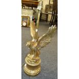 A cast gilt metal table lamp, modelled as the American Eagle, on a waited fluted plinth
