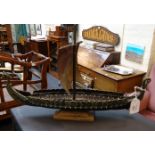 A cast metal model of a Viking longboat, made by Iron Craft Copenhagen
