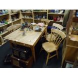 A pine table and four lath back chairs