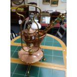 An Art Nouveau copper and brass spirit kettle, with an integral dished stand, a copper helmet