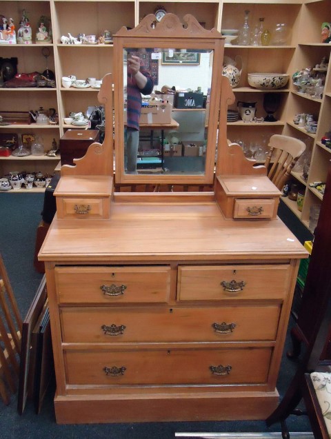 An Edwardian satinwood dressing chest, with bevelled mirror over two trinket drawers, and four