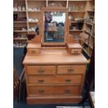 An Edwardian satinwood dressing chest, with bevelled mirror over two trinket drawers, and four