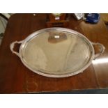 A very large silver plated two handled oval tray, bearing a presentation inscription to Colonel H