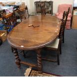 An early 20th century oak oval extending dining table, with two extra leaves, on barley twist and