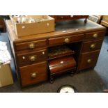 A 1930s oak and ply panel executive office twin pedestal desk