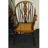 A late 19th century beech and elm wheel and stick back carver chair, with bergere cane upholstered