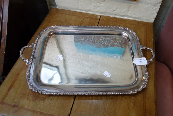 An Edwardian silver plated twin handled tray, with gadrooned rim