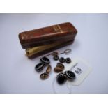 A pair of 9ct gold ovoid cufflinks, foliate engraved, a pair of banded agate cufflinks with three